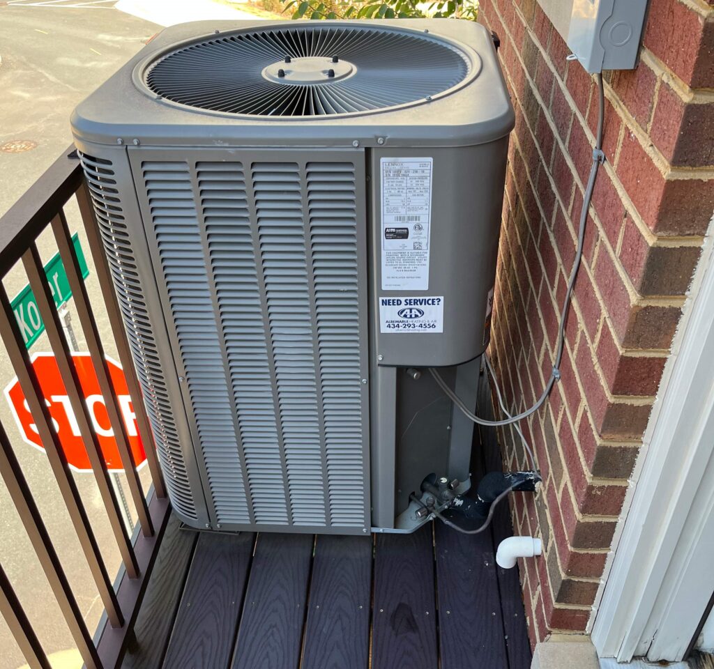 Old heat pump on townhome deck
