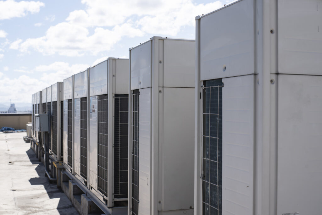 Rows of rooftop HVACs on the roofdeck of an office tower. VRF air conditioner for commercial buildings