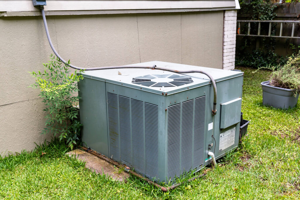 Package Air Conditioner system next to a home